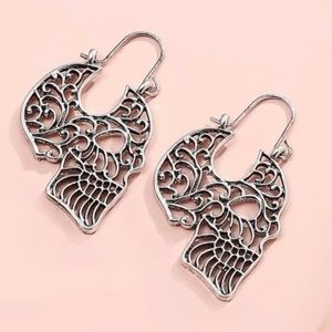 Silver Tone Metal Curlicue Skull Earrings. Zinc Alloy